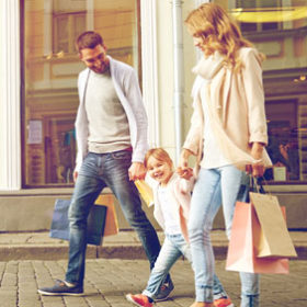 Happy family with little child and shopping.